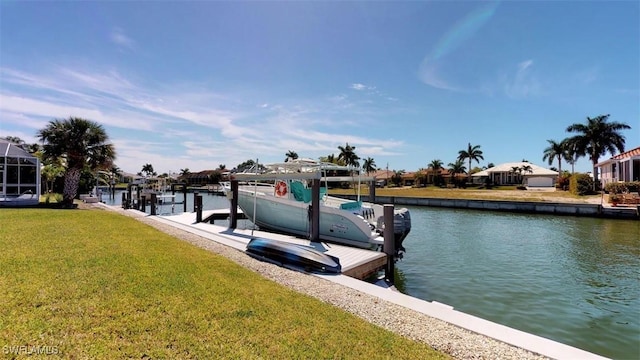 dock area with a lawn and a water view