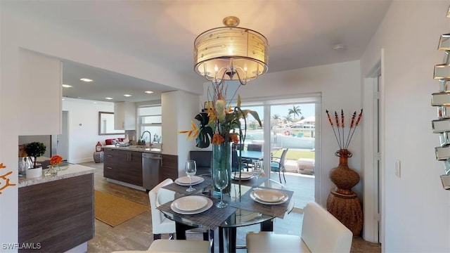 dining space featuring light hardwood / wood-style floors and a notable chandelier