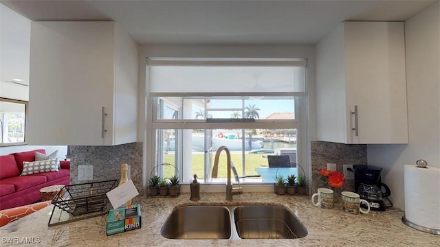 kitchen featuring sink, a wealth of natural light, and white cabinets