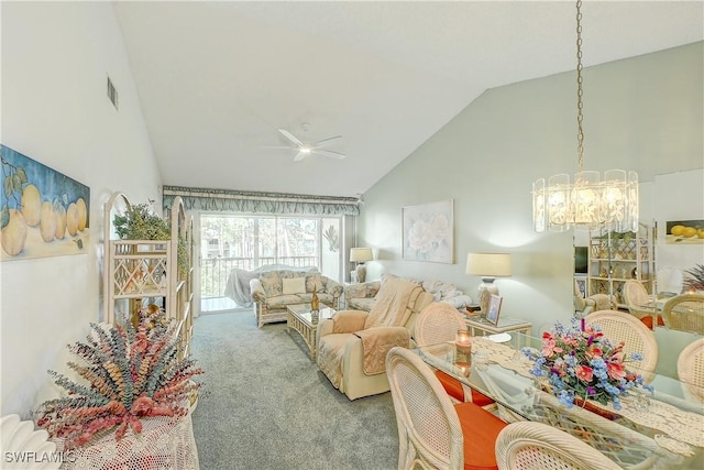 carpeted living room featuring ceiling fan with notable chandelier and high vaulted ceiling