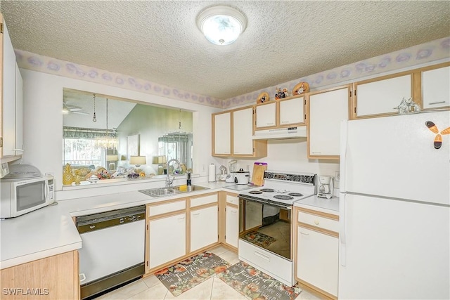 kitchen with sink, white appliances, a textured ceiling, and white cabinets