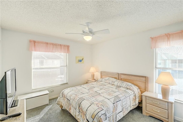 carpeted bedroom with ceiling fan and a textured ceiling