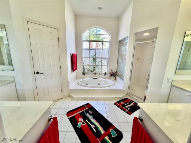 full bathroom with a jetted tub, tile patterned floors, a shower stall, and vanity