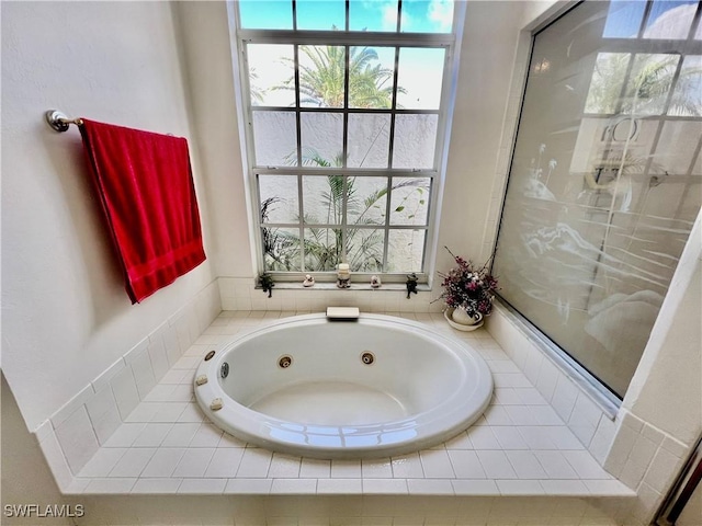 bathroom with a stall shower and a jetted tub