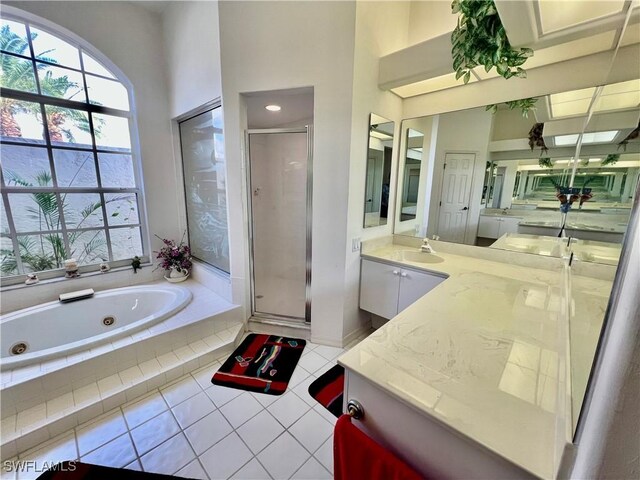 bathroom featuring a whirlpool tub, a shower stall, vanity, and tile patterned floors