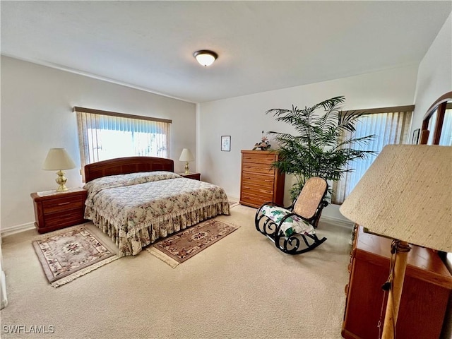 carpeted bedroom featuring baseboards