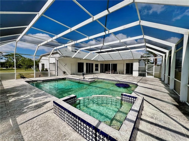 view of swimming pool with a lanai, a patio area, and a pool with connected hot tub