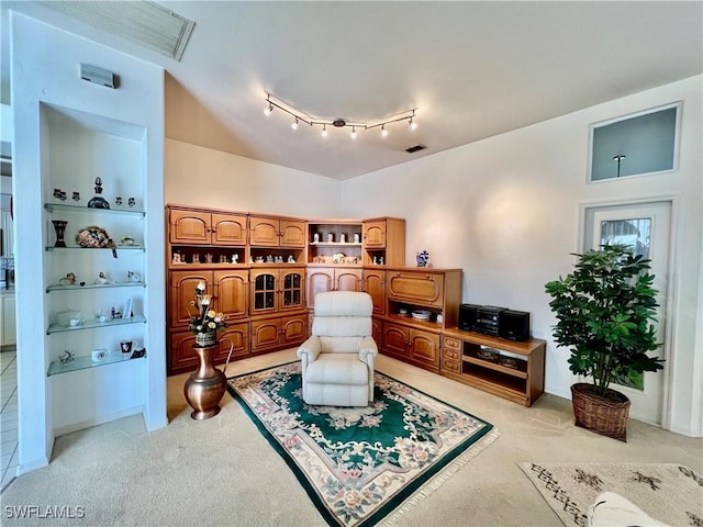 living area with visible vents and light colored carpet