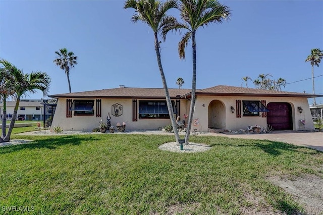 ranch-style home with a garage and a front lawn