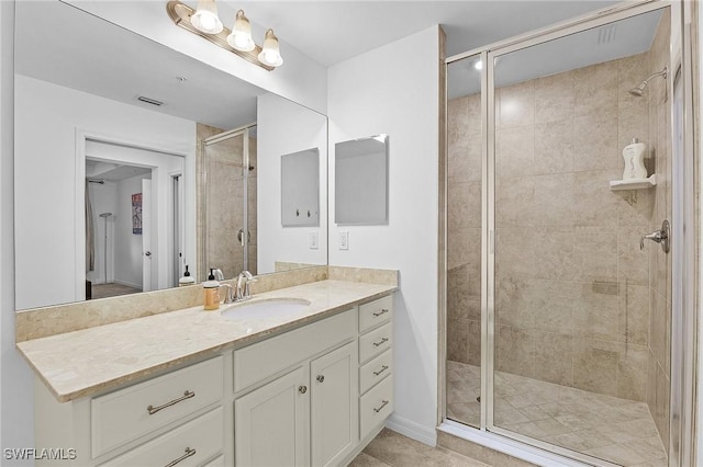 bathroom featuring vanity and a shower with shower door