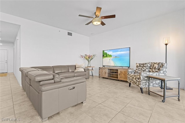 tiled living room with ceiling fan