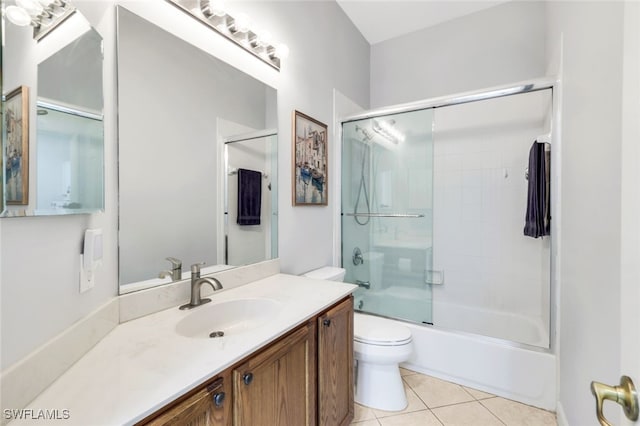 full bathroom featuring tile patterned flooring, vanity, bath / shower combo with glass door, and toilet