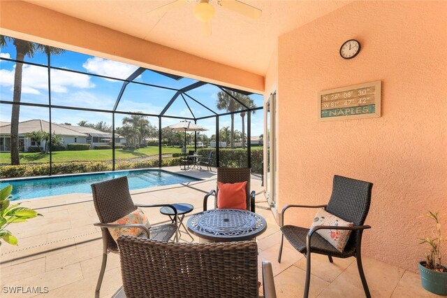 view of pool with a patio area and glass enclosure