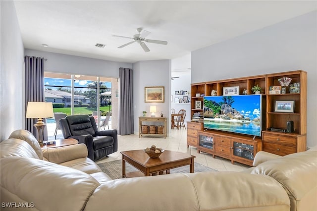 tiled living room with ceiling fan