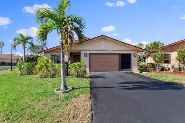 view of front of property with a garage and a front lawn