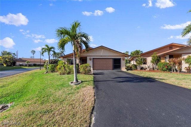 single story home featuring a garage and a front yard