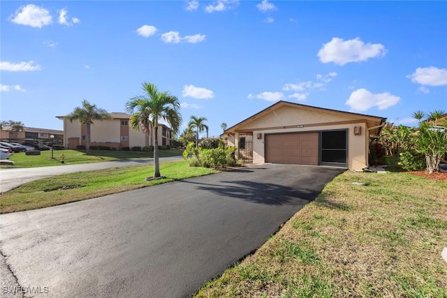 ranch-style house with a garage and a front lawn