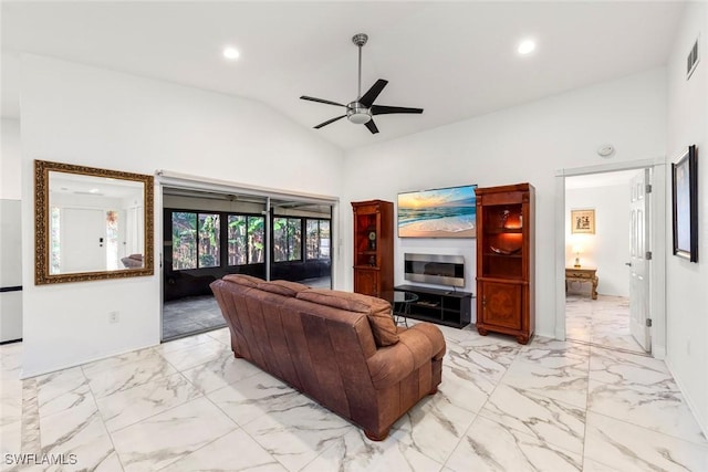 living room featuring ceiling fan and vaulted ceiling