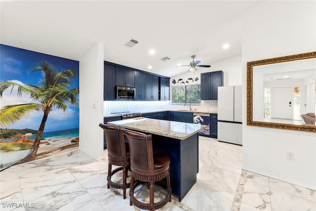 kitchen with blue cabinetry, wine cooler, appliances with stainless steel finishes, a kitchen breakfast bar, and decorative backsplash