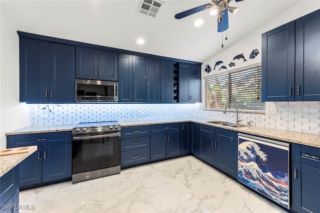 kitchen with stainless steel appliances, sink, and blue cabinets