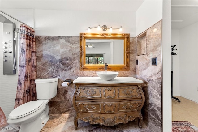 bathroom featuring vanity, toilet, a shower with shower curtain, and tile walls