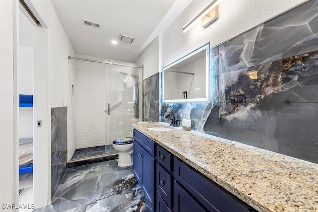 bathroom with vanity, toilet, and an enclosed shower