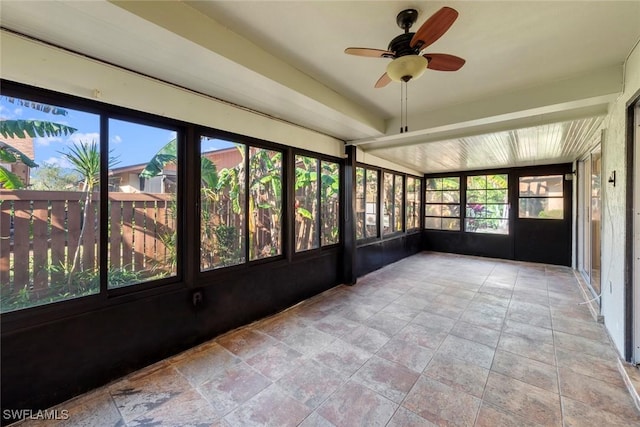 unfurnished sunroom with ceiling fan