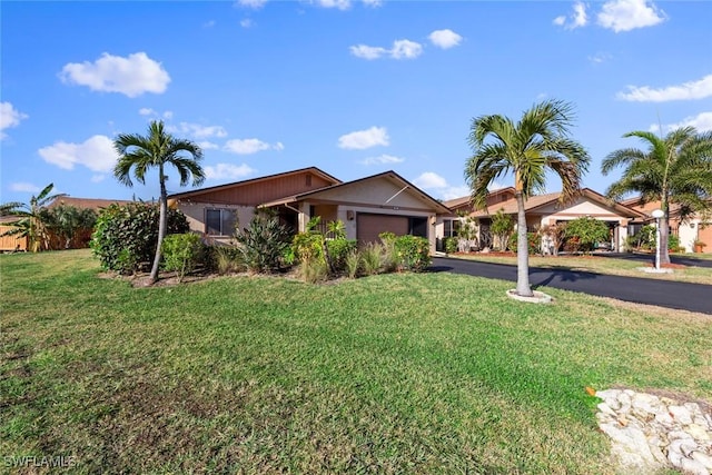 ranch-style home featuring a garage and a front yard