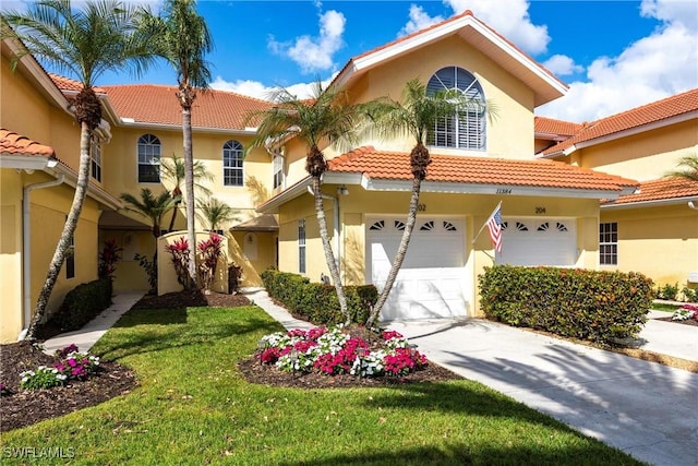 mediterranean / spanish-style house with a garage and a front yard