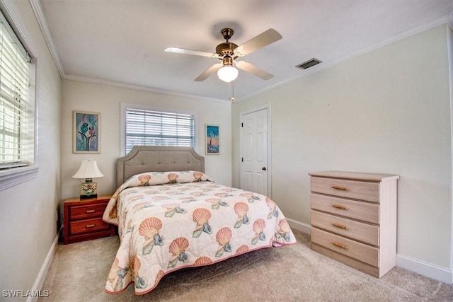 carpeted bedroom featuring crown molding and ceiling fan