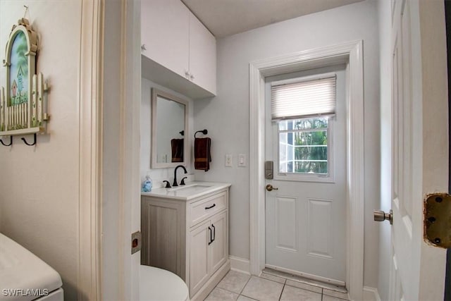 bathroom featuring vanity, tile patterned floors, and toilet