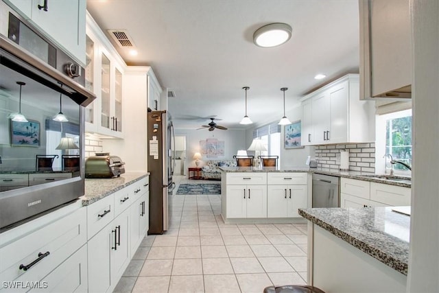 kitchen featuring pendant lighting, white cabinetry, appliances with stainless steel finishes, and sink