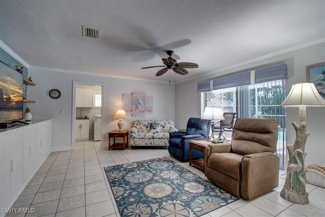 living room with light tile patterned floors, ornamental molding, and ceiling fan