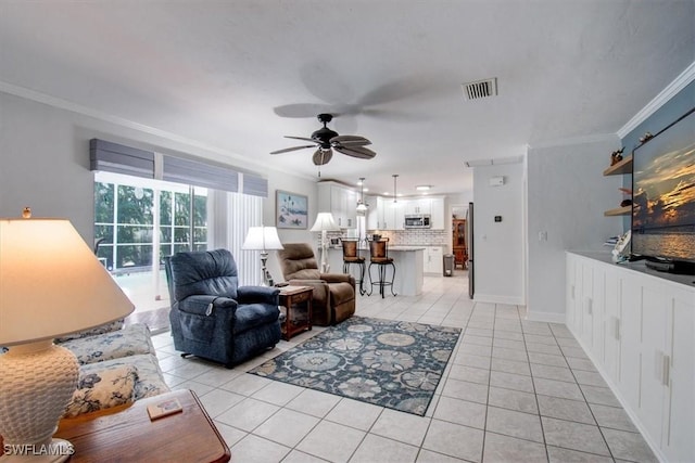 living room featuring crown molding, ceiling fan, and light tile patterned flooring