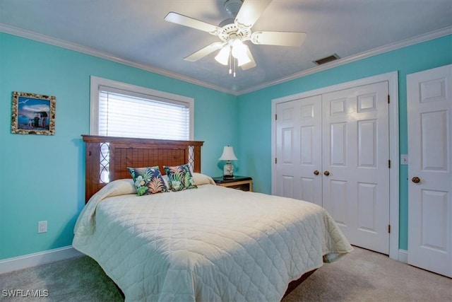 carpeted bedroom with crown molding, ceiling fan, and a closet