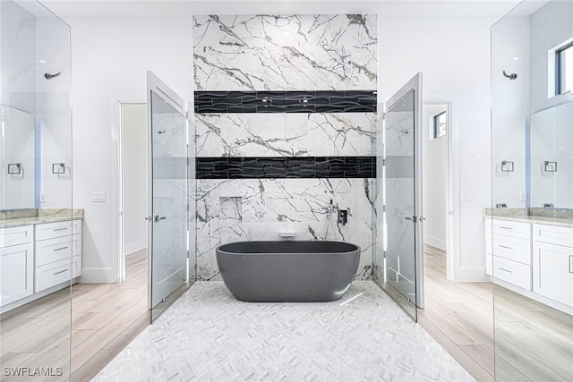 bathroom with vanity and a tub