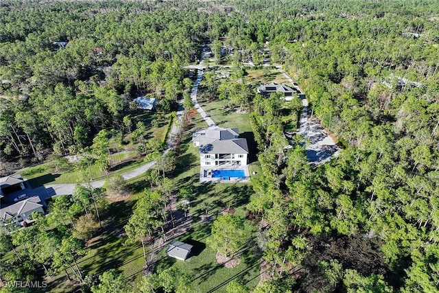 birds eye view of property with a forest view