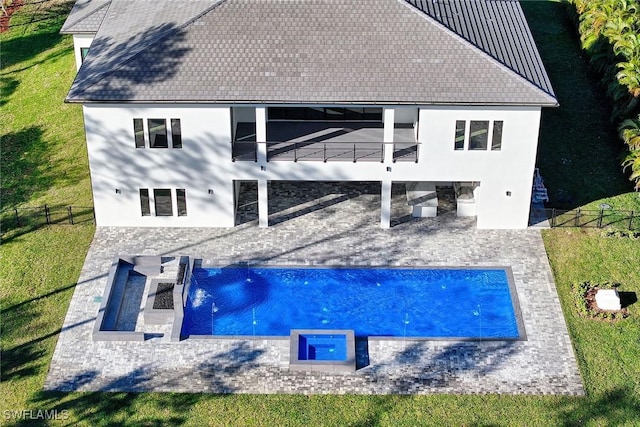 back of property with a fenced in pool, a yard, and a patio