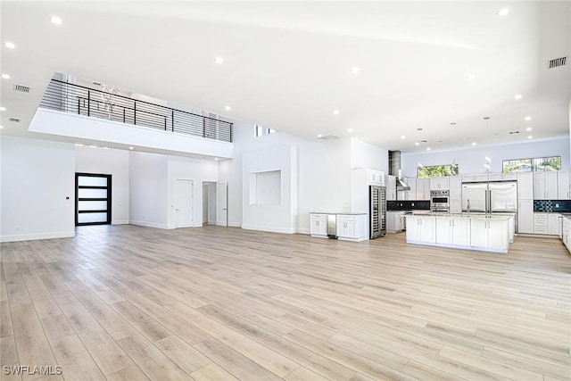 unfurnished living room featuring light hardwood / wood-style floors