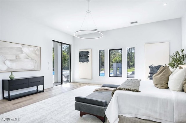 bedroom featuring wood finished floors, visible vents, baseboards, recessed lighting, and access to exterior