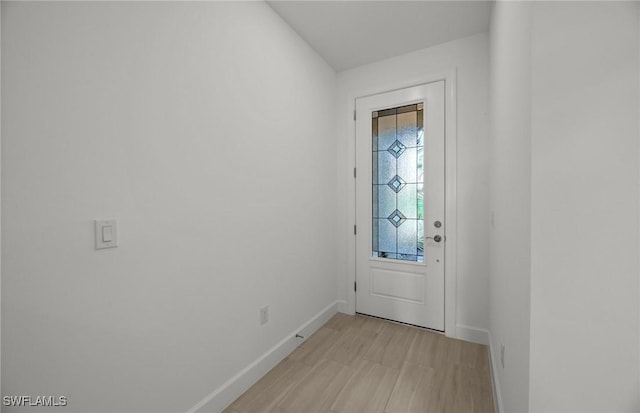 doorway with light wood-type flooring