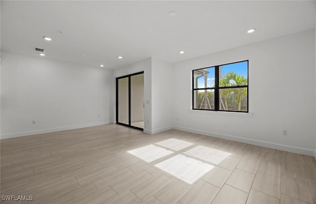 unfurnished room with light wood-type flooring