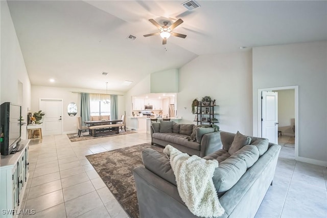 living room with ceiling fan, light tile patterned floors, and high vaulted ceiling