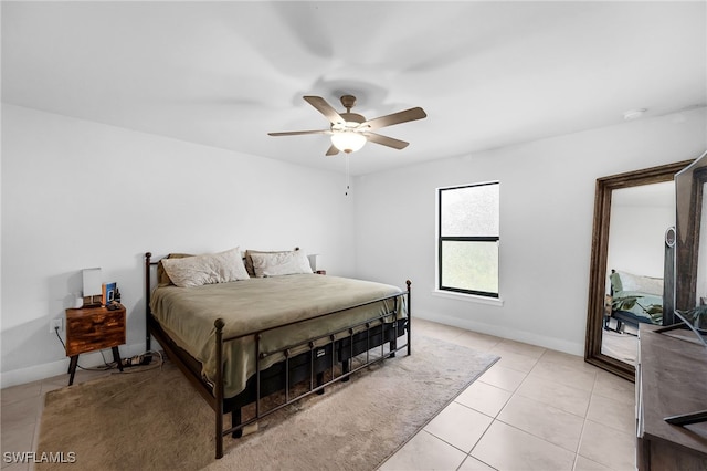 tiled bedroom featuring ceiling fan