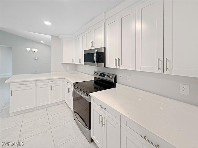 kitchen featuring white cabinetry, stainless steel appliances, decorative light fixtures, and kitchen peninsula