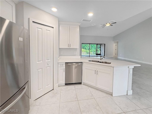 kitchen featuring white cabinetry, appliances with stainless steel finishes, kitchen peninsula, and sink