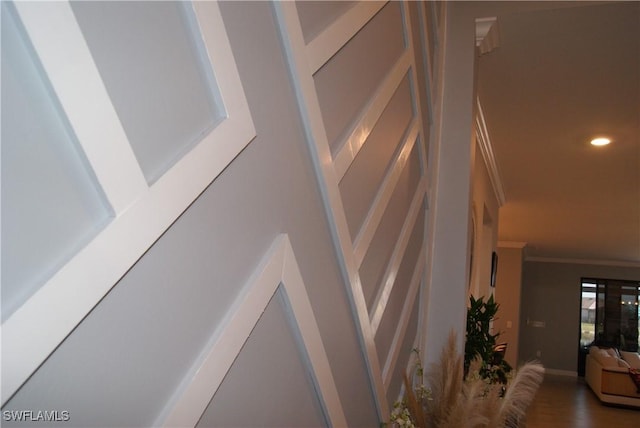 interior details featuring crown molding and wood-type flooring