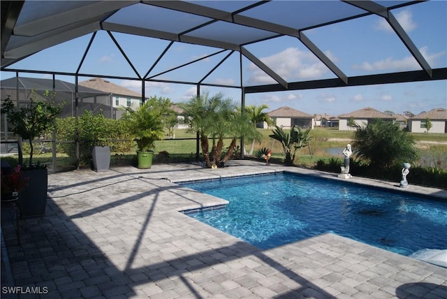 view of swimming pool featuring a lanai and a patio area