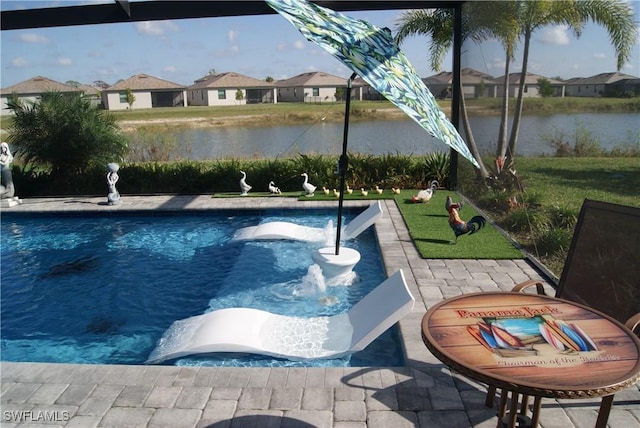 view of pool with a water view and a patio area