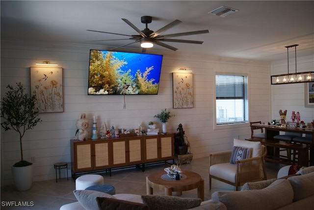 living room with tile patterned floors and ceiling fan